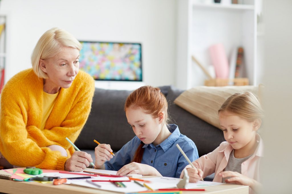 Mature Woman Drawing with two Kids